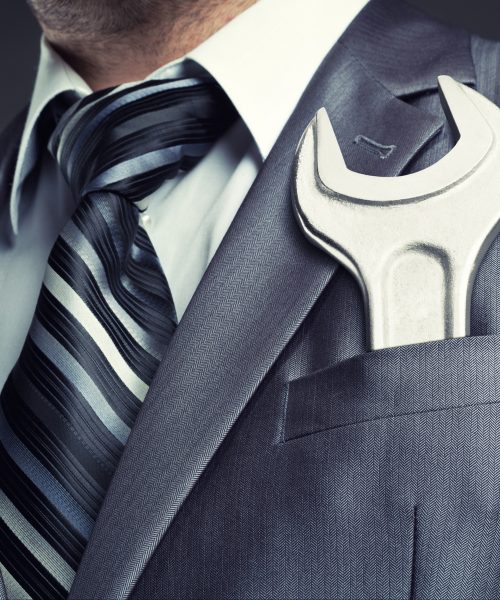 Business man with wrench in pocket